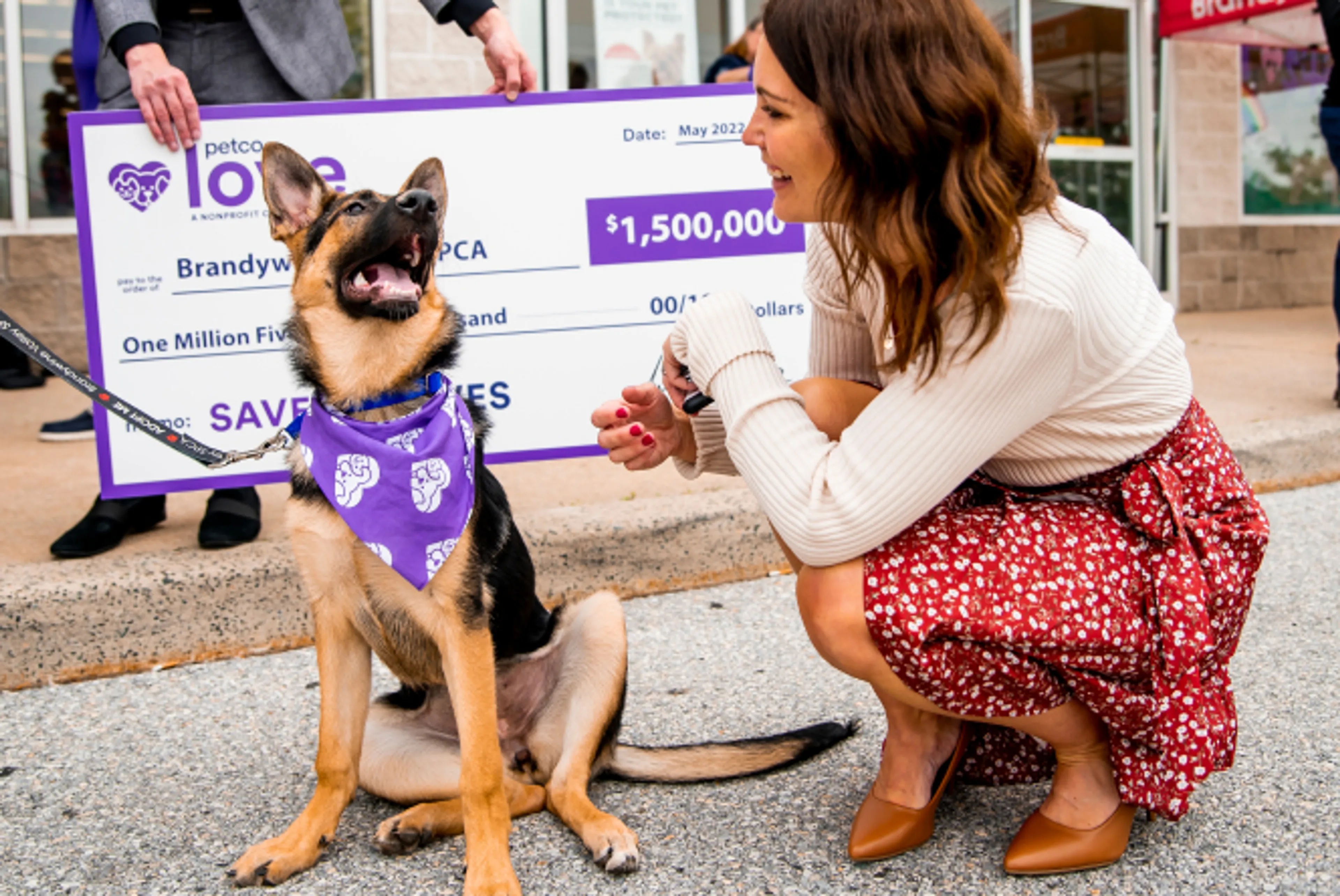 Dog in front of a big check